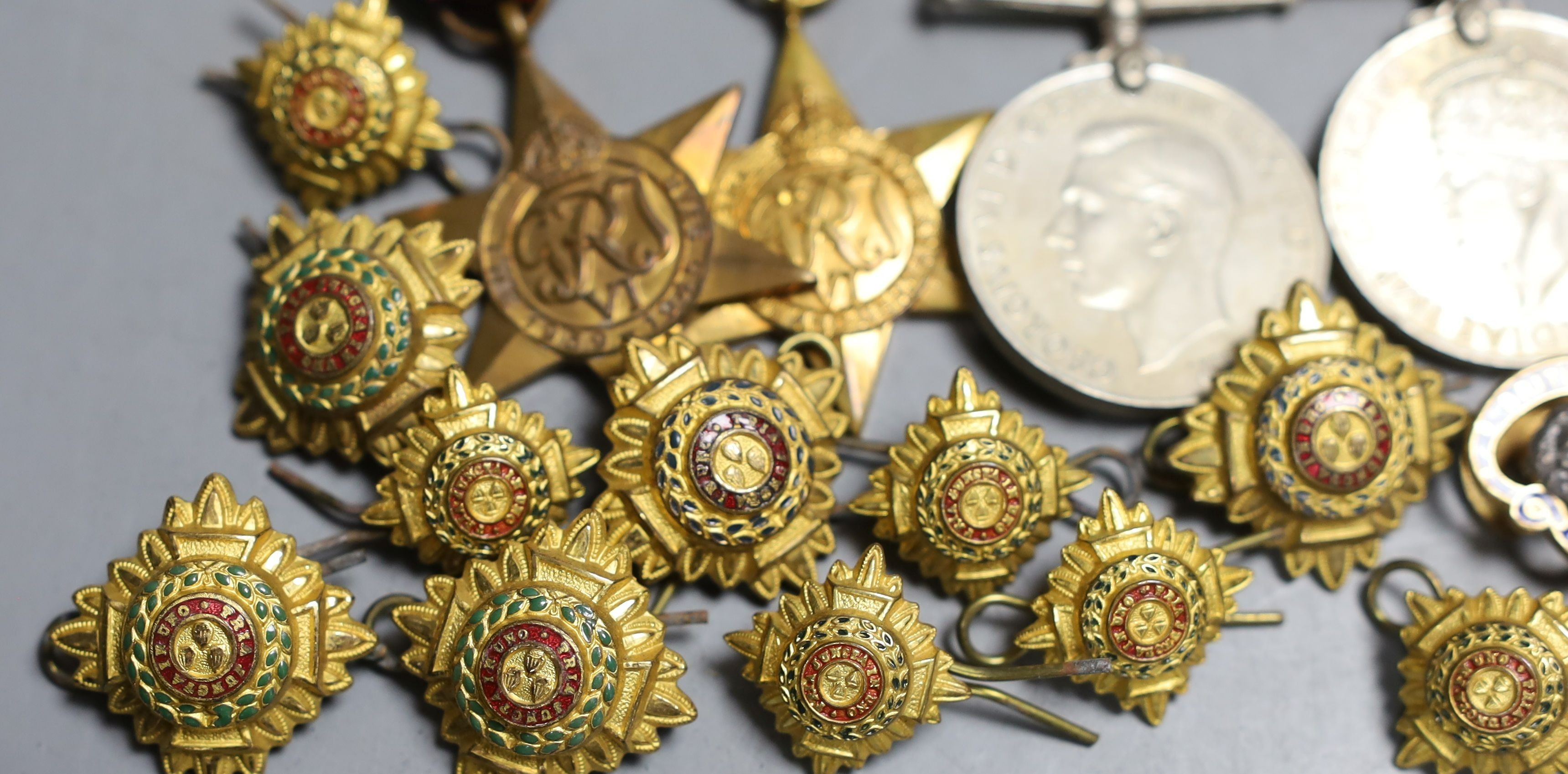 A group of five WW2 medals, together with a selection of cap badges and a pocket watch